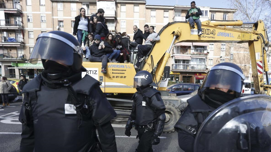 Activistas suben a una excavadora para tratar de evitar el desalojo de una vivienda en Madrid, capital de España