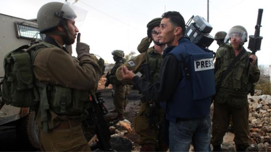 Un periodista palestino entre soldados israelíes