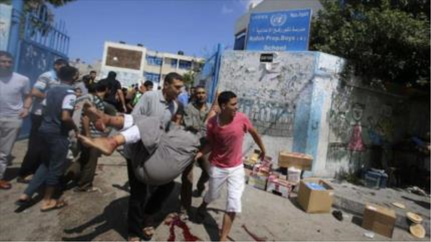 Palestinos ayudan a los heridos de los bombardeos israelí contra una escuela de UNRWA en Gaza 