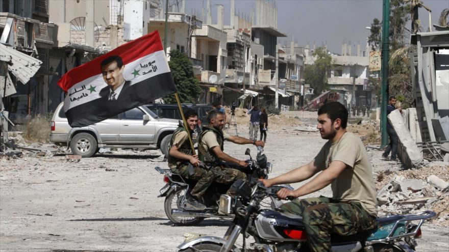 Fuerzas sirias llevan la bandera del país en la ciudad occidental de Al-Quseir