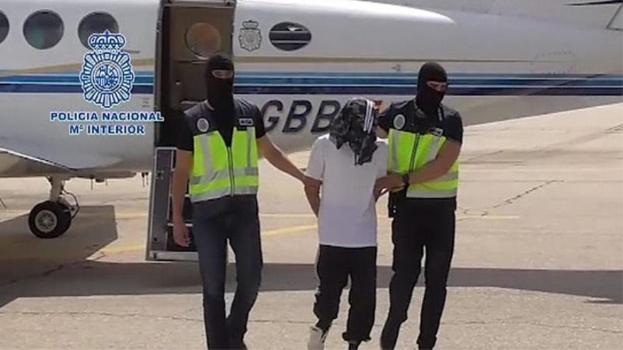 Los agentes de seguridad custodiando al detenido en Melilla, en su traslado a Madrid.