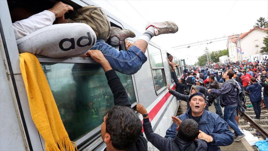 Solicitantes de asilo se precipitan sobre un tren destinado a la frontera húngara en la estación de tren de la ciudad croata de Tovarnik (este), 20 de septiembre de 2015.