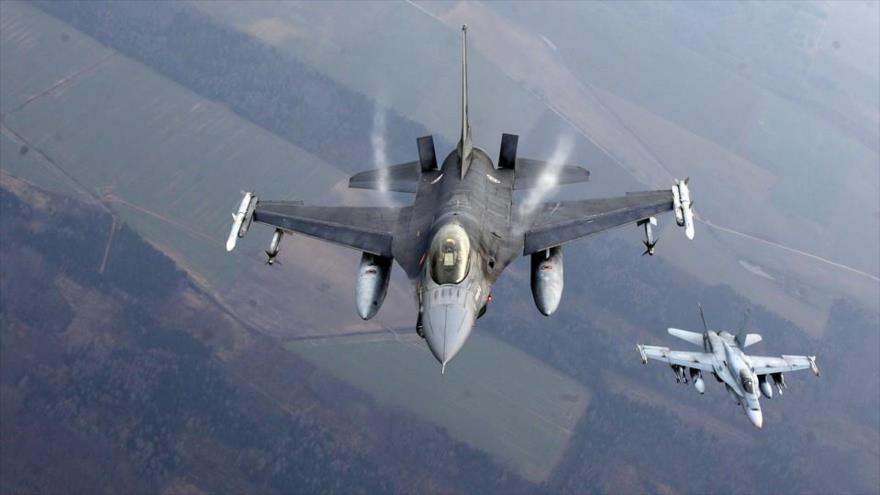 Un avión de combate portugués, izquierda, y un avión de combate de Canadá participan en una de las maniobras de la OTAN en el espacio aéreo de Lituania.