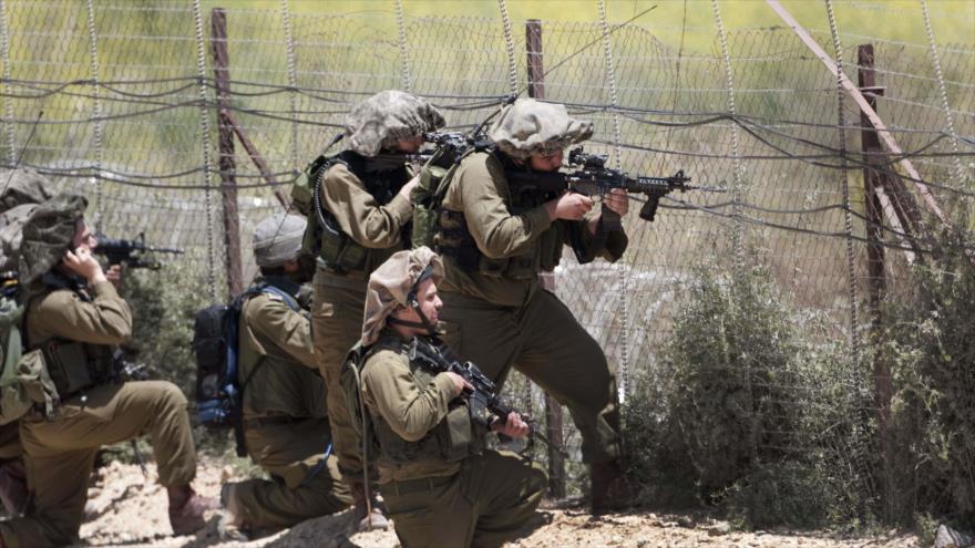 Soldados israelíes apuntan contra palestinos en una protesta en Cisjordania.