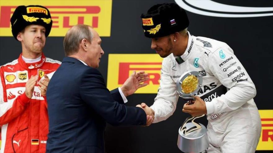 El piloto británico Lewis Hamilton, ganador del Gran Premio de Rusia de Fórmula Uno (derecha), felicitado por el presidente ruso, Vladimir Putin. 11 de octubre de 2015