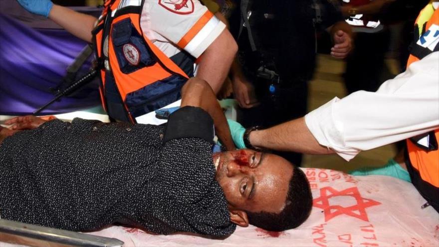 Personal sanitario israelí lleva a Mila Abtum, eritreo de 29 años de edad, disparado y linchado en una estación de autobuses en el sur de los territorios ocupados por un militar israelí y varios colonos. 18 de octubre de 2015.