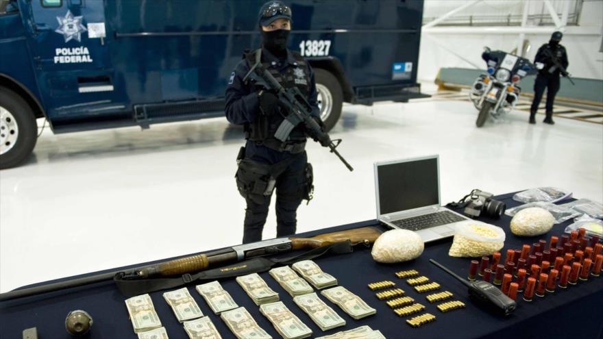 Dinero, armas, municiones y drogas decomisadas durante un operativo contra el narcotráfico en México.