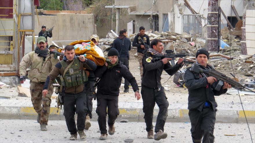 Las fuerzas iraquíes y miembros del servicio de la lucha antiterrorista del país llevan el cuerpo de una fuerza durante las batallas con el grupo terrorista EIIL (Daesh, en árabe) en la provincia de Al-Anbar, 4 de enero de 2016.