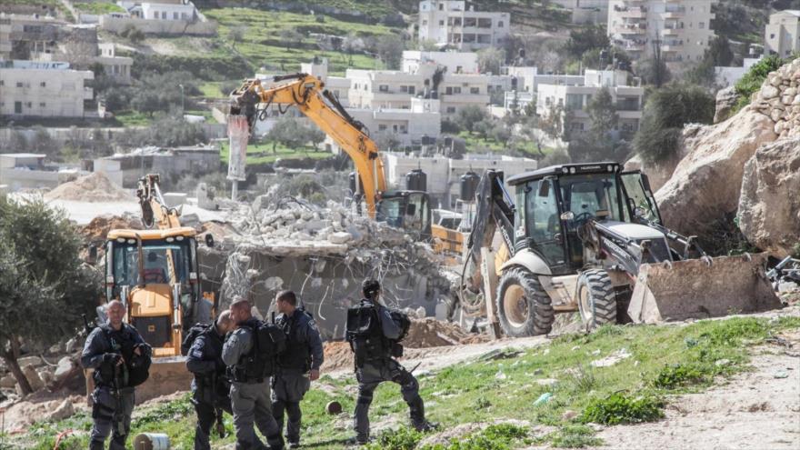 Palaexcavadora del régimen israelí demoliendo casas palestinas.