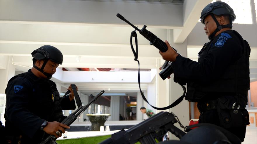Agentes indonesios patrullan en el aeropuerto internacional de Ngurah Rai en Denpasar, capital de la isla de Bali, un día después de los atentados en la capitalina ciudad de Yakarta, 15 de enero de 2016.