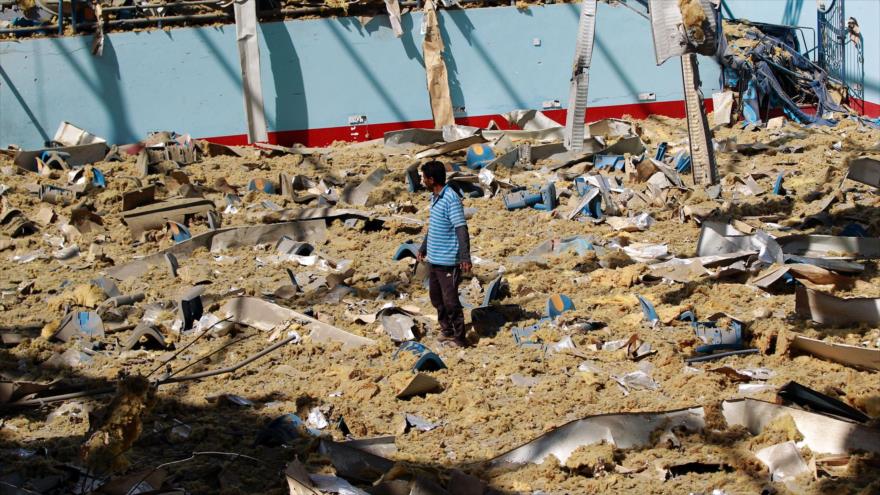Un civil yemení camina entre los escombros generados por un bombardeo saudí contra un estadio deportivo en Saná, la capital de Yemen.