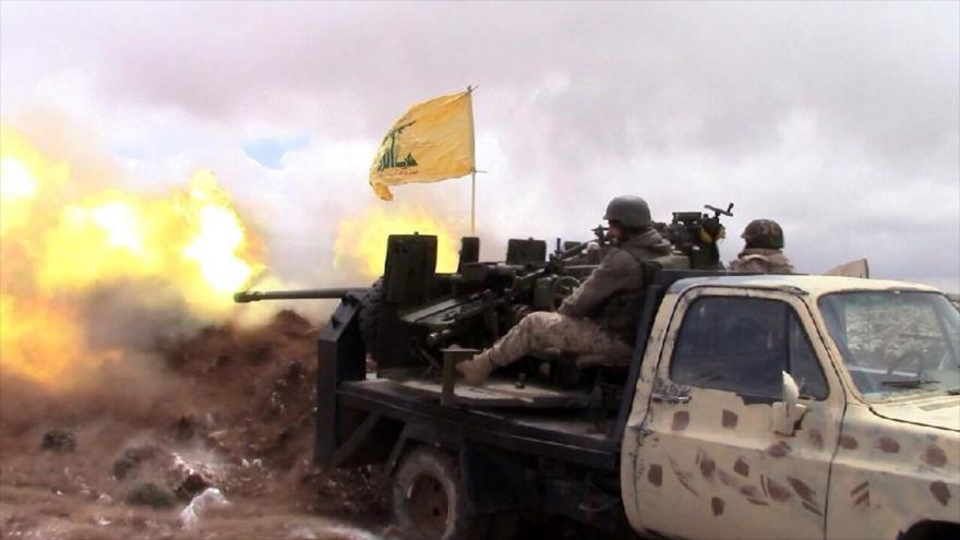 Combatientes de Hezbolá lanzan fuego.