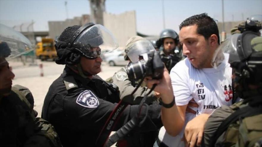 Fuerzas israelíes impiden a un periodista palestino hacer fotos.