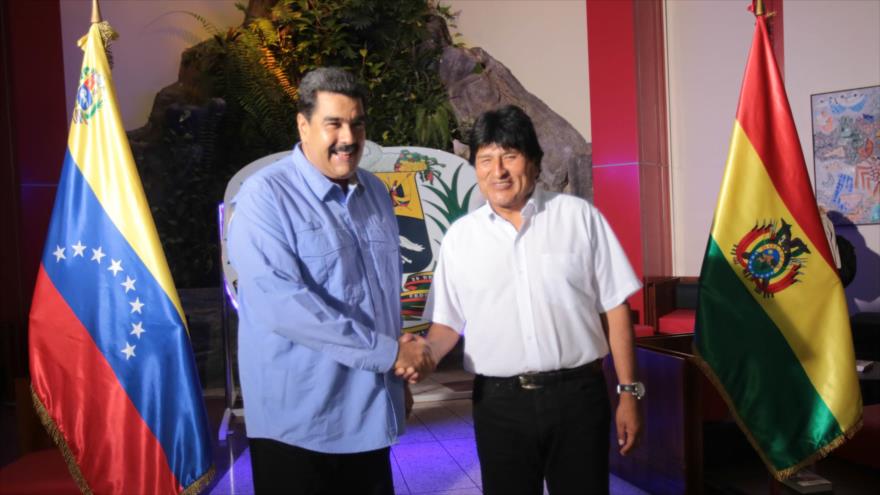El presidente de Venezuela, Nicolás Maduro (izda.), da la mano a su homólogo boliviano, Evo Morales.