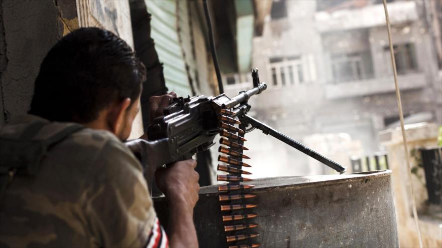 Miembro de un grupo armado en Siria ataca a las posiciones gubernamentales en Alepo.