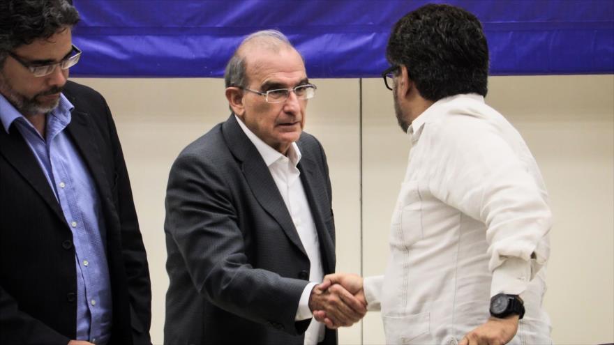 El jefe de la delegación del Gobierno de Colombia para las conversaciones de paz, Humberto de la Calle, se da la mano con Iván Márquez, el miembro de FARC, antes de una conferencia de prensa en el Palacio de las Convenciones de La Habana, 12 de agosto de 2016.