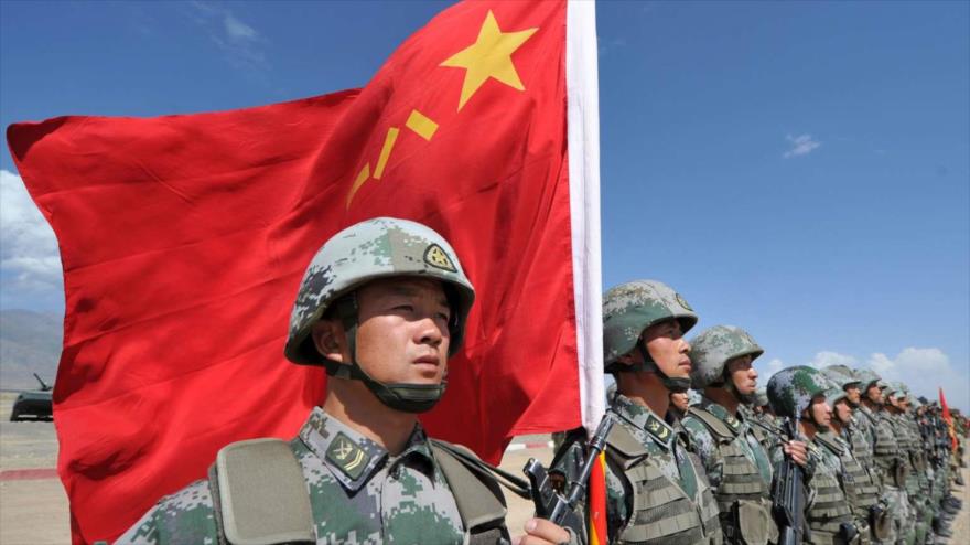 Un soldado chino sostiene una bandera china durante unos ejercicios militares conjuntos de la Organización para la Cooperación de Shanghái (OCS) en el campo de formación Edelweiss, a unos 200 km de Bishkek, la capital de Kirguistán, 19 de septiembre de 2016.