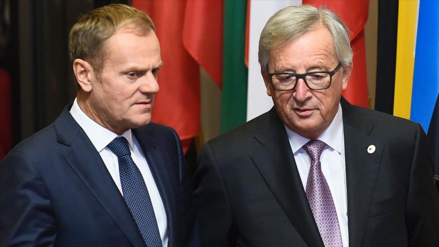 El presidente del Consejo Europeo, Donald Tusk (izda.) habla con el presidente de la Comisión Europea (CE), Jean-Claude Juncker, antes del inicio de la cumbre UE-Canadá para firmar el acuerdo de libre comercio CETA, en Bruselas, 30 de octubre de 2016.