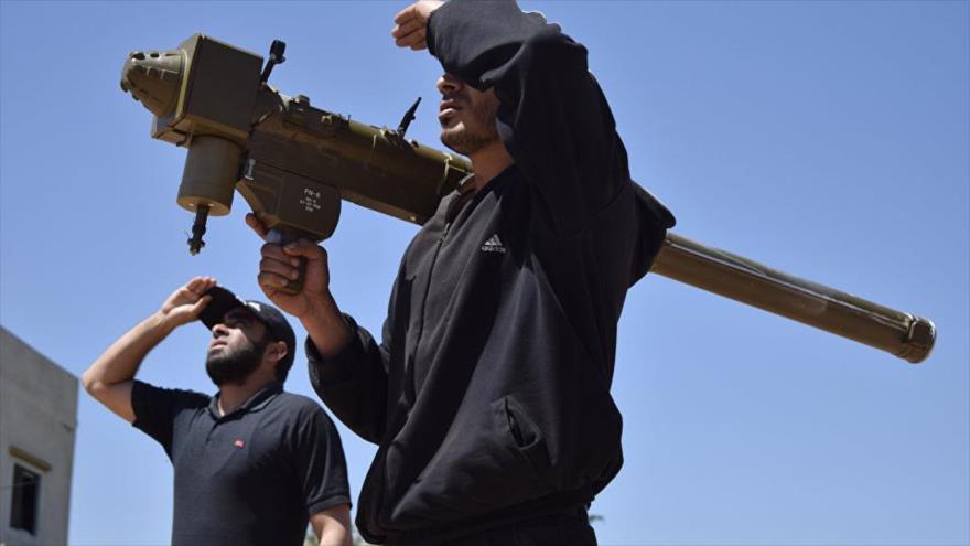 Los rebeldes vigilan el cielo sosteniendo un sistema de defensa aérea portátil (MANPAD) FN-6 en la aldea siria de Teir Maalah, al norte de Homs, el 20 de abril de 2016.