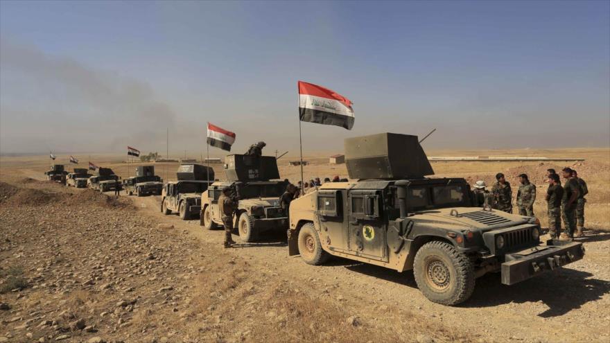 Vehículos de las fuerzas populares iraquíes a las afueras de la localidad de Bartella, situada en la provincia norteña de Nínive.