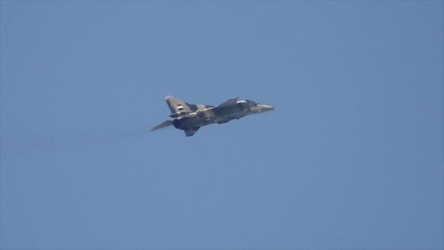 Un caza modelo MIG-23, de producción rusa, de la Fuerza Aérea Siria vuela sobre la localidad de Ain Tarma, en el este de la capital siria, Damasco, 25 de febrero de 2016.