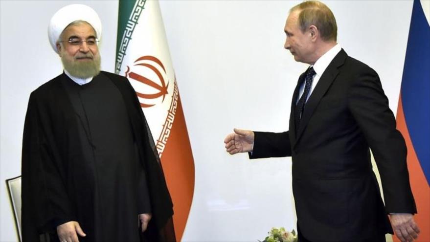 El presidente ruso, Vladimir Putin, (dcha.) recibe a su homólogo iraní, Hassan Rohani, durante su reunión en Bakú, 8 de agosto de 2016.