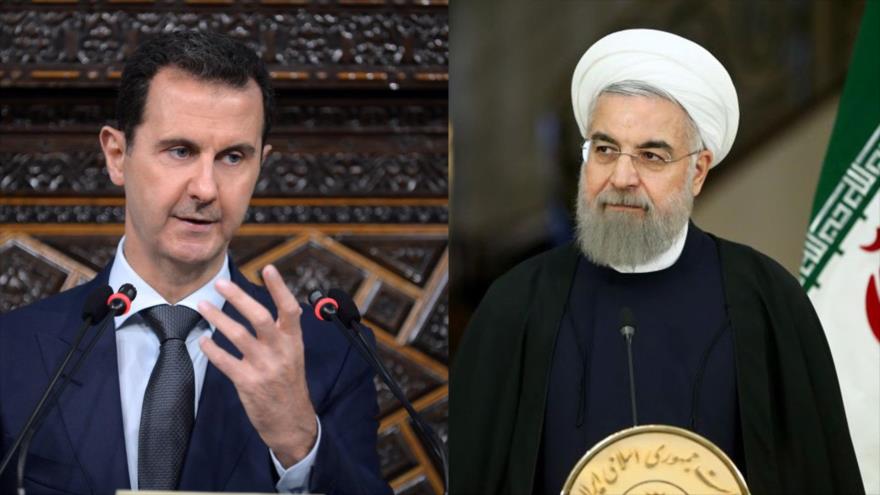 El presidente iraní, Hasan Rohani (dcha.) y su homólogo sirio, Bashar al-Asad. 