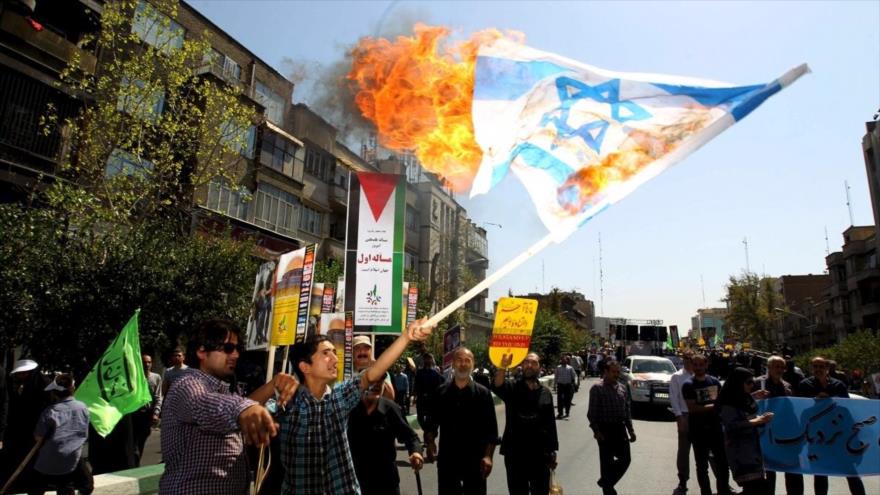 Manifestantes iraníes queman una bandera israelí durante la marcha del Día Mundial de Al-Quds en Teherán, capital persa, 1 de junio de 2016.