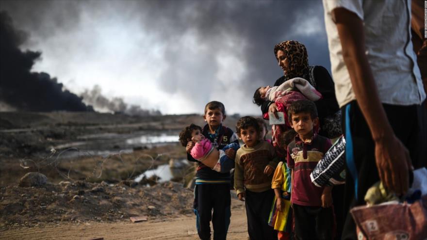 Familias iraquíes huyen de los ataques terroristas contra Mosul.