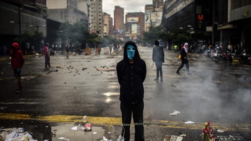 Un manifestante opositor venezolano participa en un bloqueo para protestar contra el presidente Nicolás Maduro, Caracas, 19 de julio de 2017.