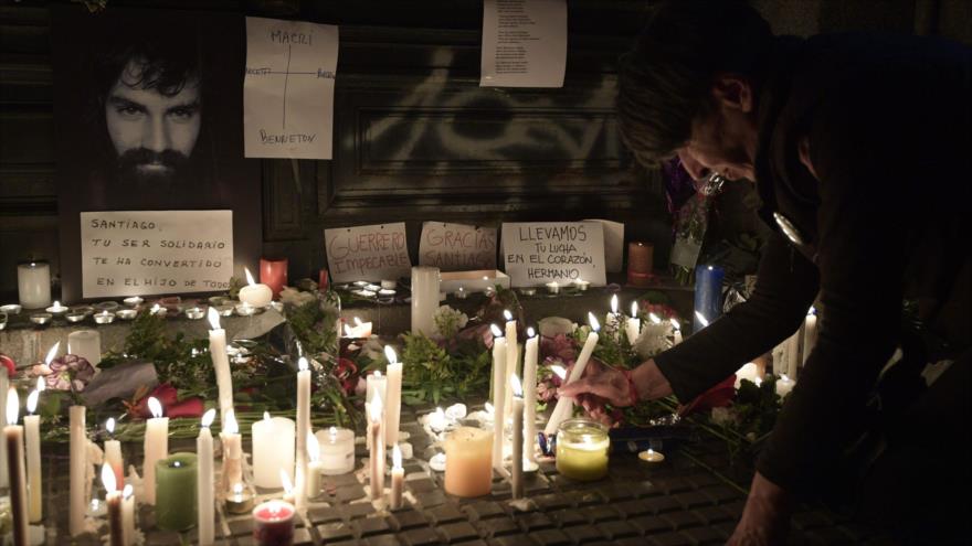 Mujer argentina deposita una vela encendida en memoria del activista Santiago Maldonado, 21 de octubre de 2017.