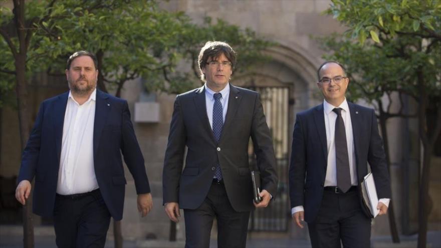 El expresidente de la Generalitat catalana, Carles Puigdemont (centro), junto a Oriol Junqueras (izda.), y Jordi Turull, en Barcelona.
