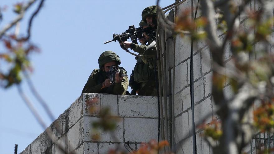 Las fuerzas israelíes apuntan sus armas hacia los manifestantes palestinos, 31 de marzo de 2018.