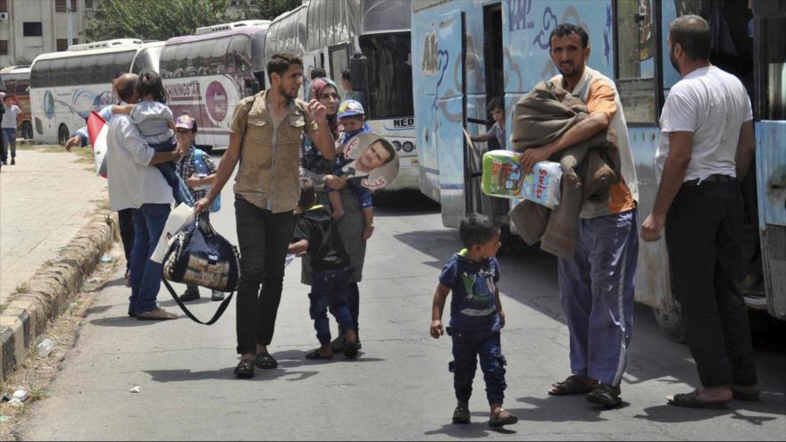 Los desplazados sirios regresan a su antiguo barrio de Al-Waer, en Homs, en el centro de Siria.