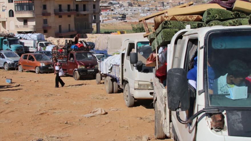 Desplazados sirios regresan a sus hogares en la ciudad de Al-Qalamun, 23 de julio de 2018. (Foto: AFP)