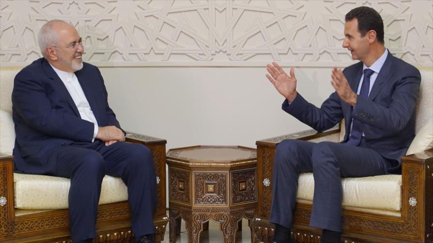 El canciller iraní, Mohamad Yavad Zarif (izda.), se reúne con el presidente sirio, Bashar al-Asad, en Damasco, 3 de septiembre de 2018. (Foto: SANA)