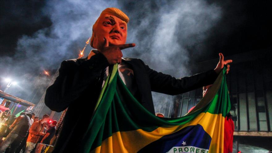 Un partidario del ultraderechista Jair Bolsonaro lleva una máscara del presidente de EE.UU., Donald Trump, Sao Paulo, 28 de octubre de 2018. (Foto: AFP)