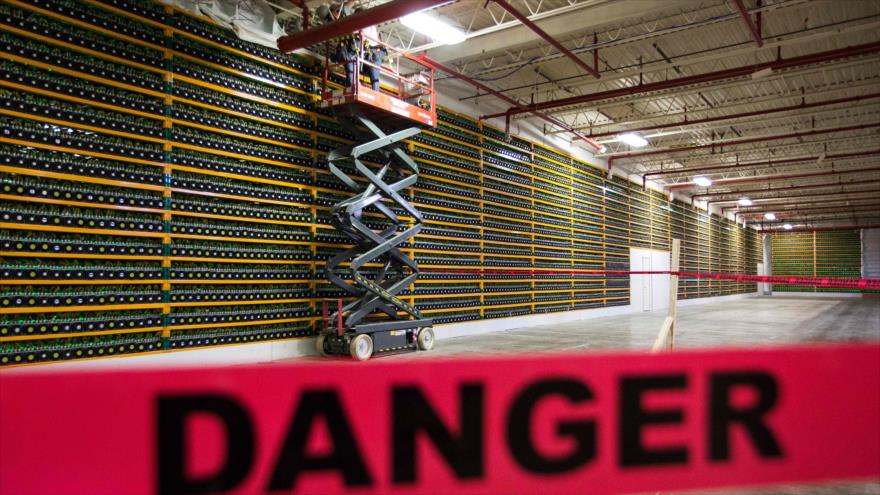 En esta foto los trabajadores de la construcción usan un elevador a lo largo de un muro de la minería de bitcóin en Bitfarms, Quebec, Canadá. (Fuente: AFP).