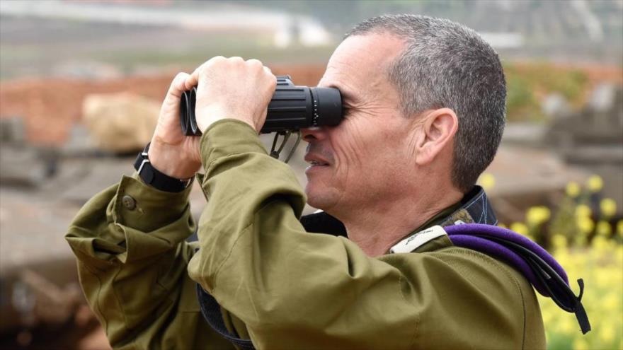 El general israelí Yoel Strick observa una localidad en el norte de los territorios ocupados palestinos a través de binoculares.