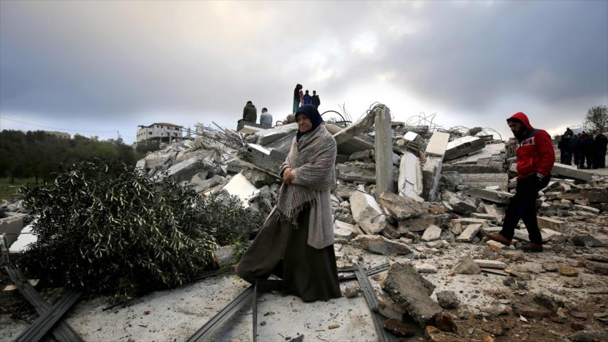 Mujer palestina revisa los escombros de su casa después de que fue demolida por las fuerzas israelíes en Cisjordania, 7 de marzo de 2019. (Foto: AFP)
