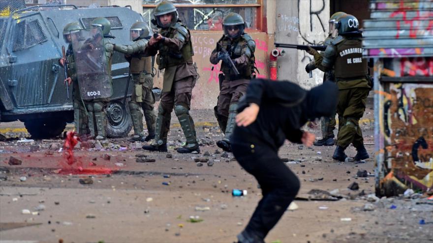 Policía chilena ataca a un manifestante en la protesta en Santiago, la capital, 4 de noviembre de 2019. (Foto: AFP)