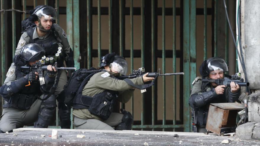 Soldados israelíes apuntan contra manifestantes palestinos en la ciudad de Al-Jalil (Hebrón), en Cisjordania, 9 de diciembre de 2019. (Foto: AFP)