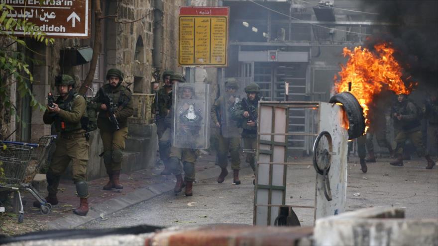 Soldados israelíes se enfrentan a manifestantes palestinos en la ciudad de Al-Jalil (Hebrón), la ocupada Cisjordania, 9 de diciembre de 2019.