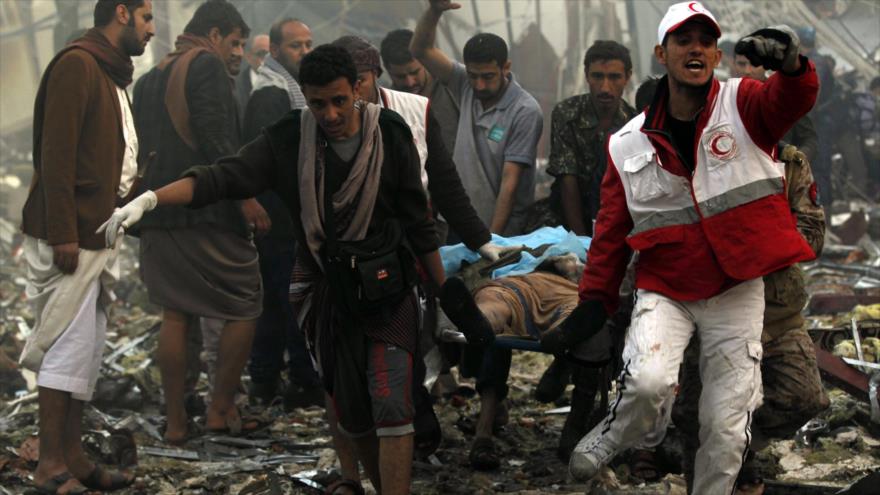 Yemeníes tratan de ayudar a las víctimas de un bombardeo saudí.