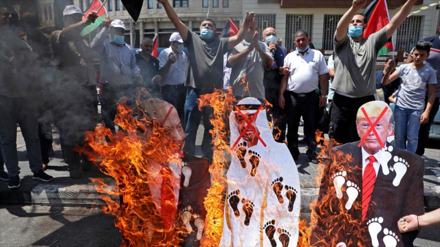 Manifestantes palestinos queman efigies de responsables del acuerdo entre Israel y los Emiratos Árabes, Cisjordania, 14 de agosto de 2020. (Foto: AFP)