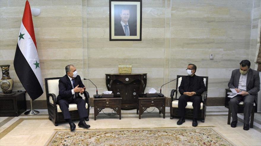 Husein Arnus, premier designado en Siria, recibe al viceministro de Defensa de Irán Ebrahim Mahmudzade, en Damasco, 27 de agosto de 2020. (Foto: SANA)
