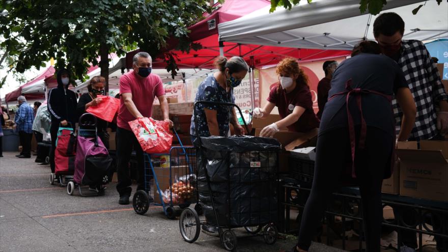 Reparten comida y alimentos entre la gente en un banco de alimentos en Nueva York (EE.UU.), 18 de septiembre de 2020. (Foto: AFP)