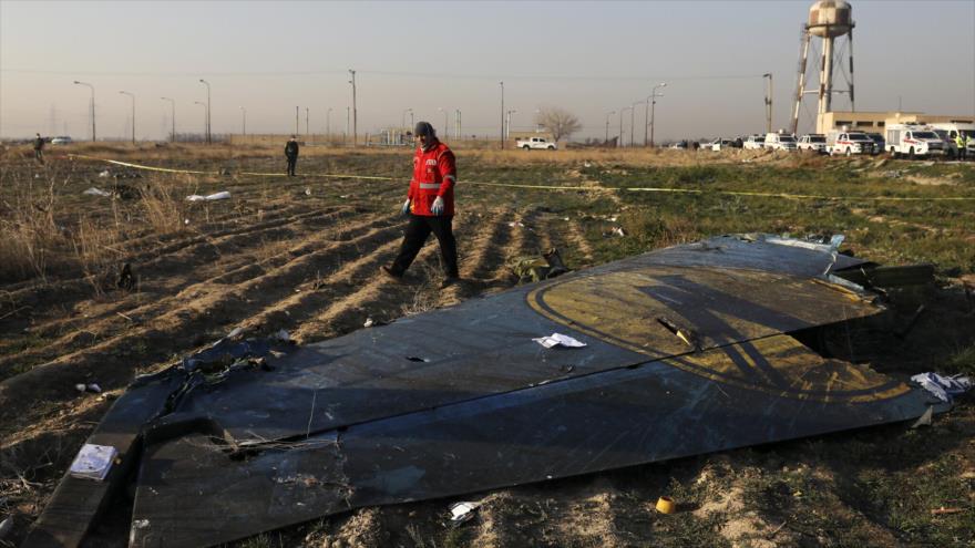 Un rescatista registra la escena donde se estrelló un avión ucraniano al suroeste de la capital iraní, Teherán, 8 de enero de 2020. (Foto: AP)
