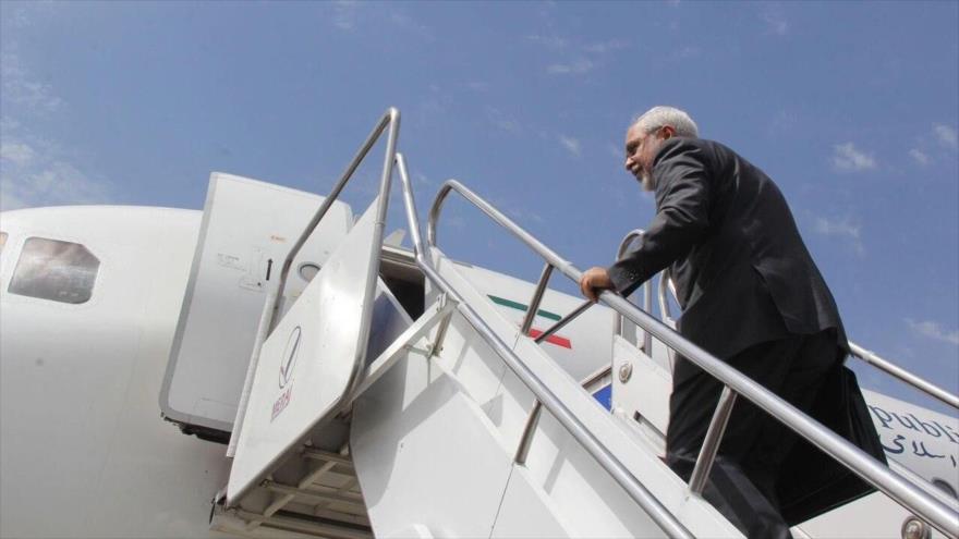El canciller iraní, Mohamad Yavad Zarif, sube las escaleras de un avión.