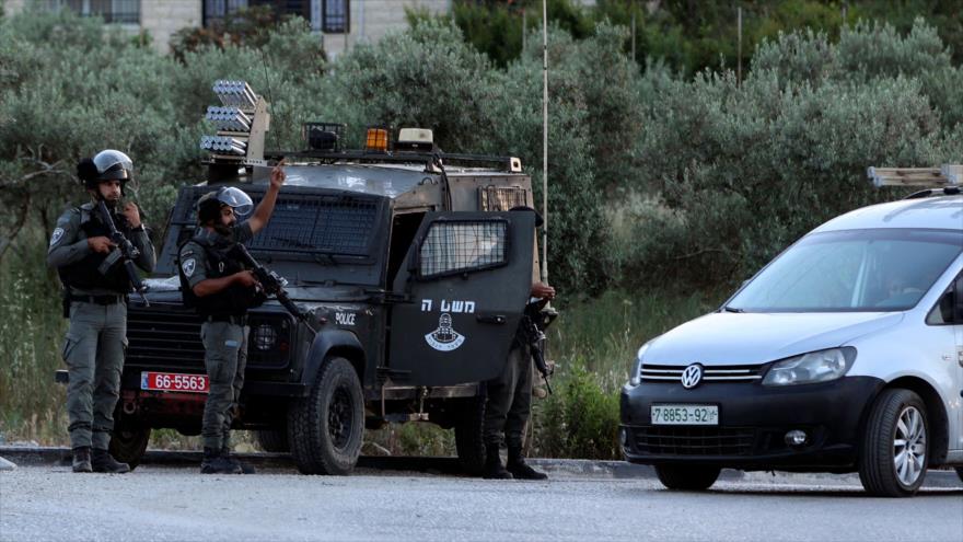 Policía israelí detiene un vehículo civil palestino en el cruce de Zaatara al sur de la ciudad de Nablus en la ocupada Cisjordania, 11 de mayo de 2021. (Foto: AFP)